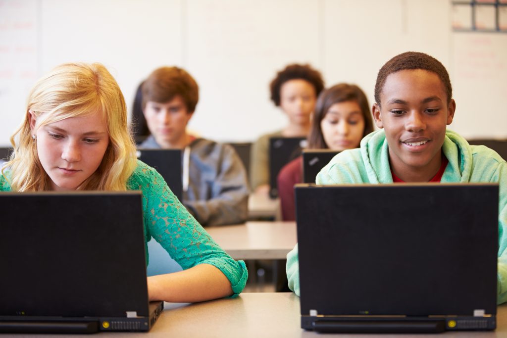 Class of students using laptop computers